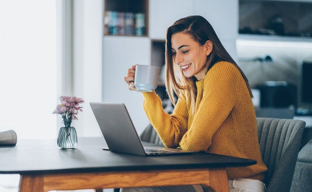 A woman looking at her laptop