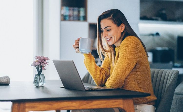 A woman looking at her laptop